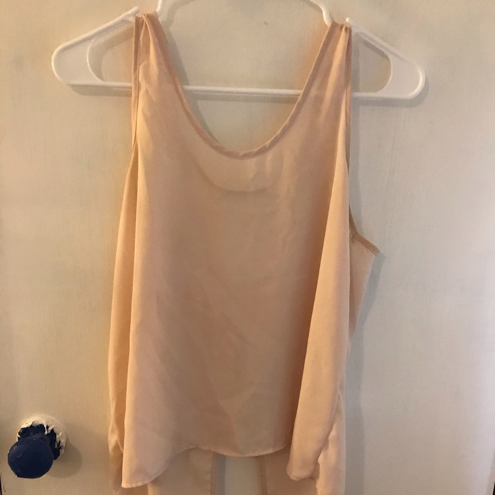Cute blush colored tank top with lace back & bow